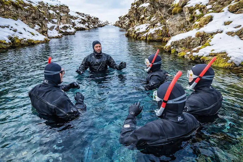 people entering silfra for a session